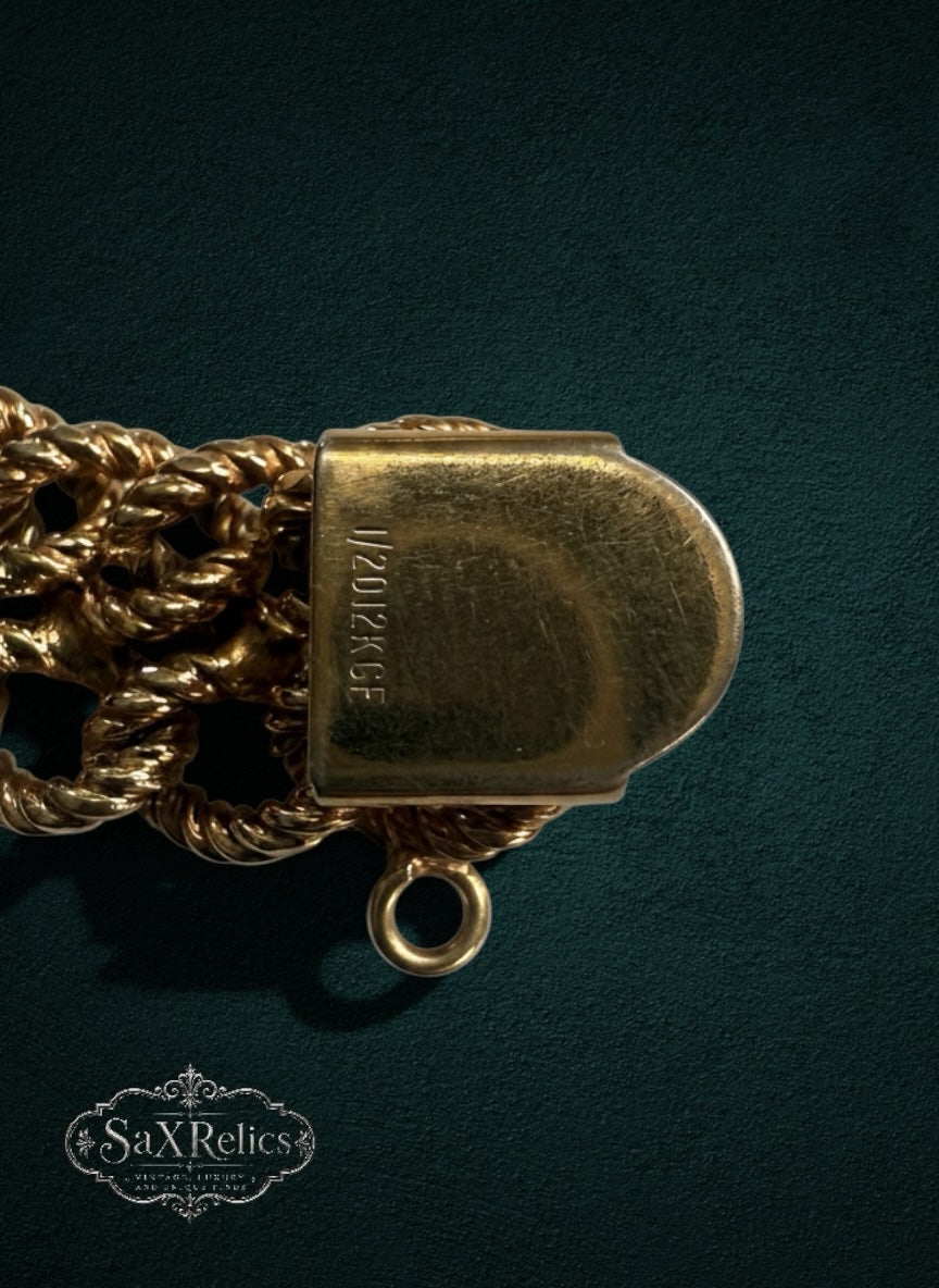 My Store gold-filled multi-strand rope chain bracelet clasp with 1/20 12K GF hallmark on a dark green background.