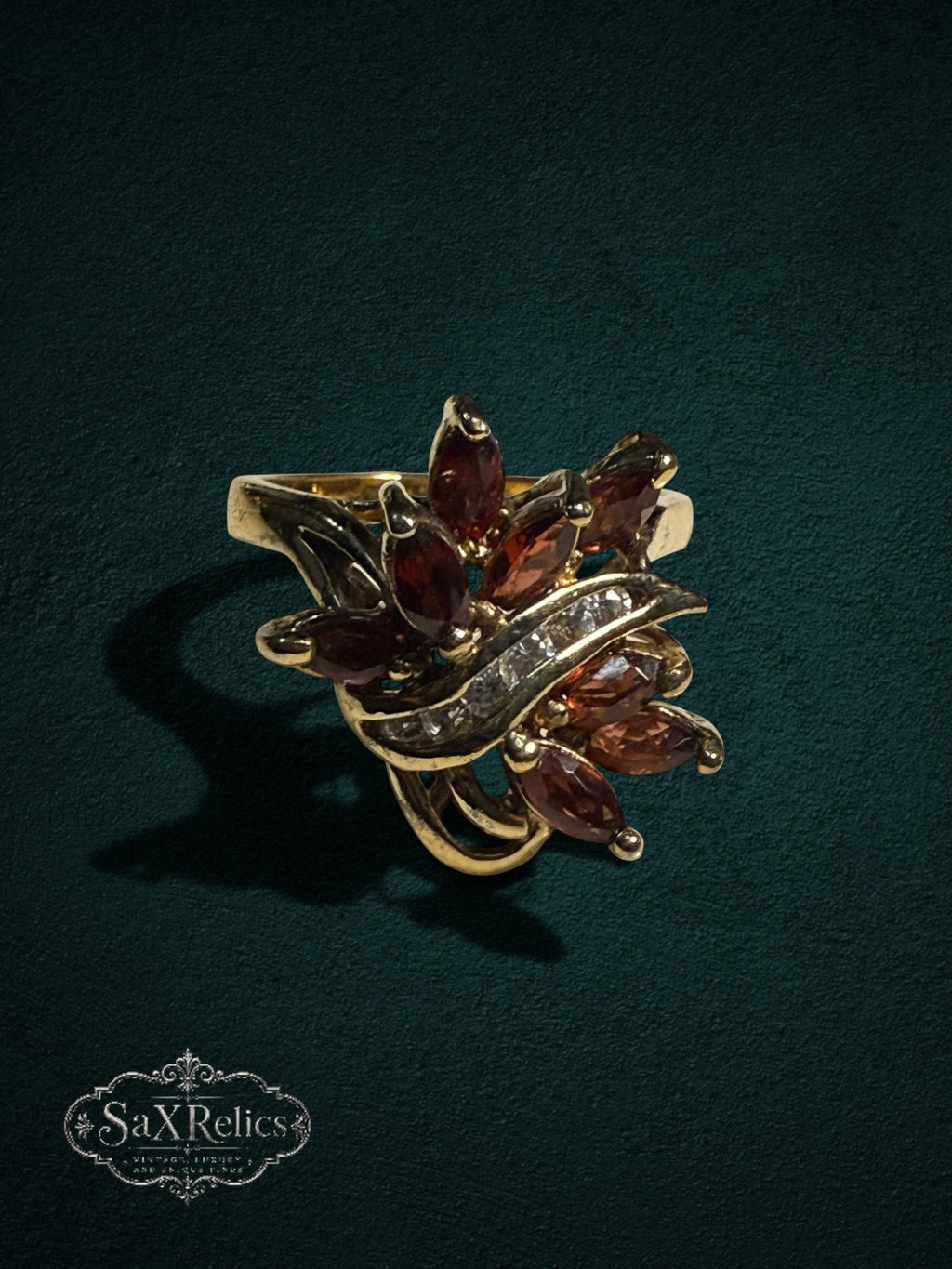 My Store vintage-inspired gold statement ring featuring marquise-cut red garnet stones and a clear crystal accent.