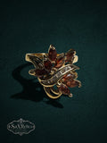 My Store vintage-inspired gold statement ring featuring marquise-cut red garnet stones and a clear crystal accent.