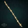 My Store SAXRelics vintage-inspired gold-tone link bracelet featuring oval-cut multi-colored gemstones on a dark background
