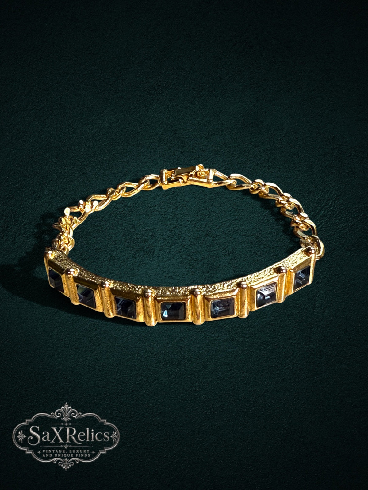 SaX Relics gold-tone link bracelet featuring midnight-blue square-cut stones and a textured metal finish.