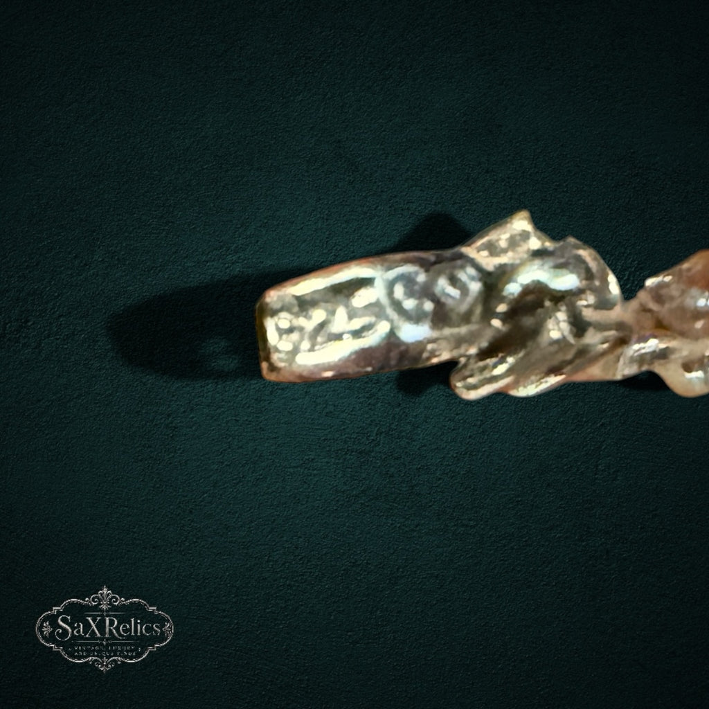 SaX Relics sterling silver bracelet detail showing marquise rubies and diamond chips on a dark background