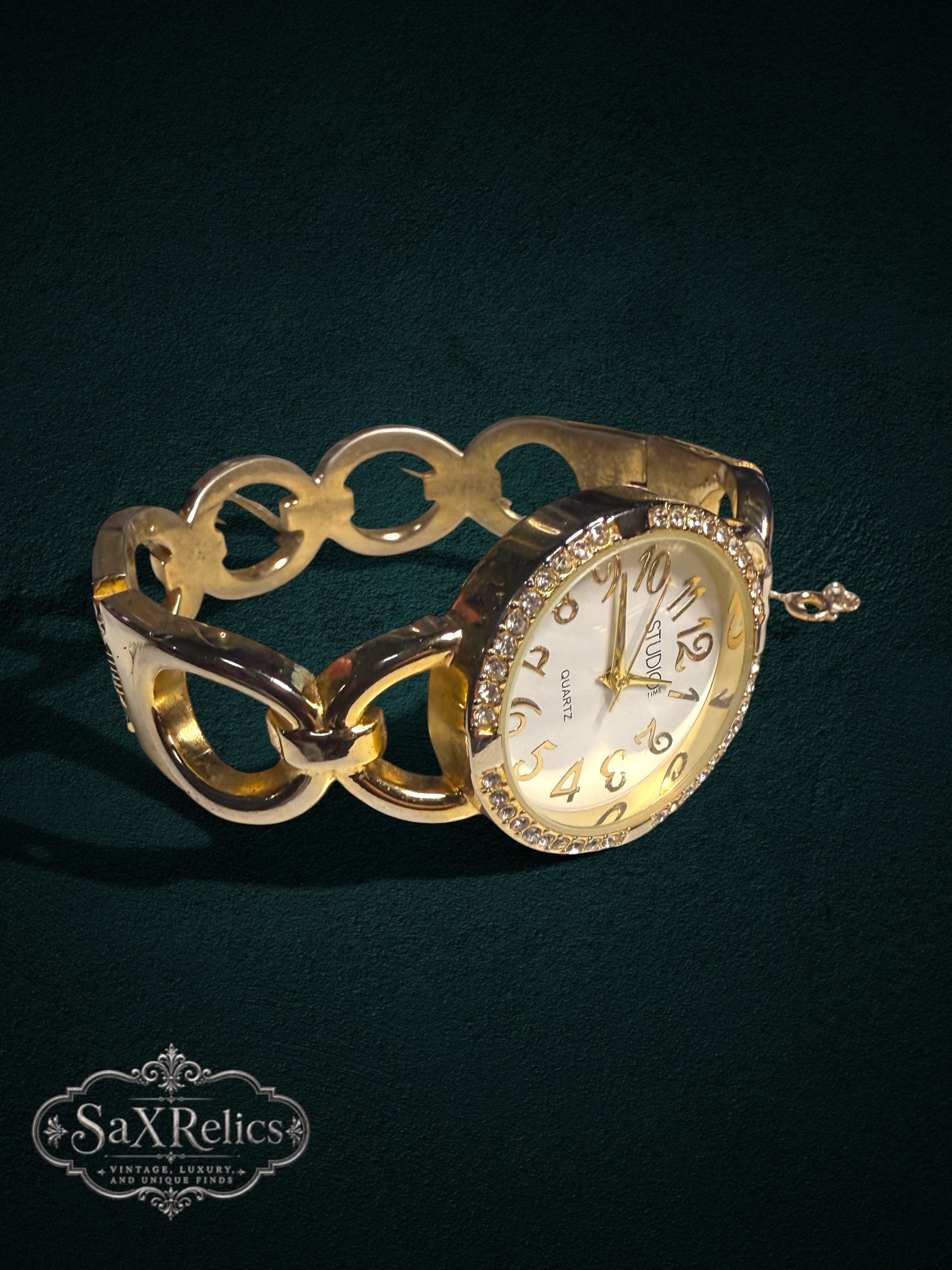 My Store gold-tone quartz wristwatch featuring a crystal-encrusted bezel and a decorative chain-link bracelet.