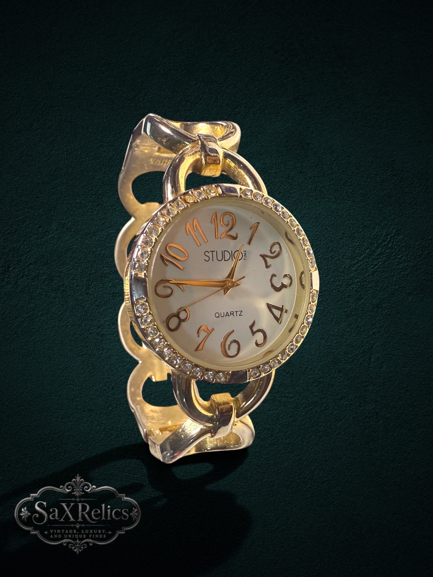 My Store gold-tone Studio Time quartz watch with a crystal-encrusted bezel and a unique chain-link bracelet.