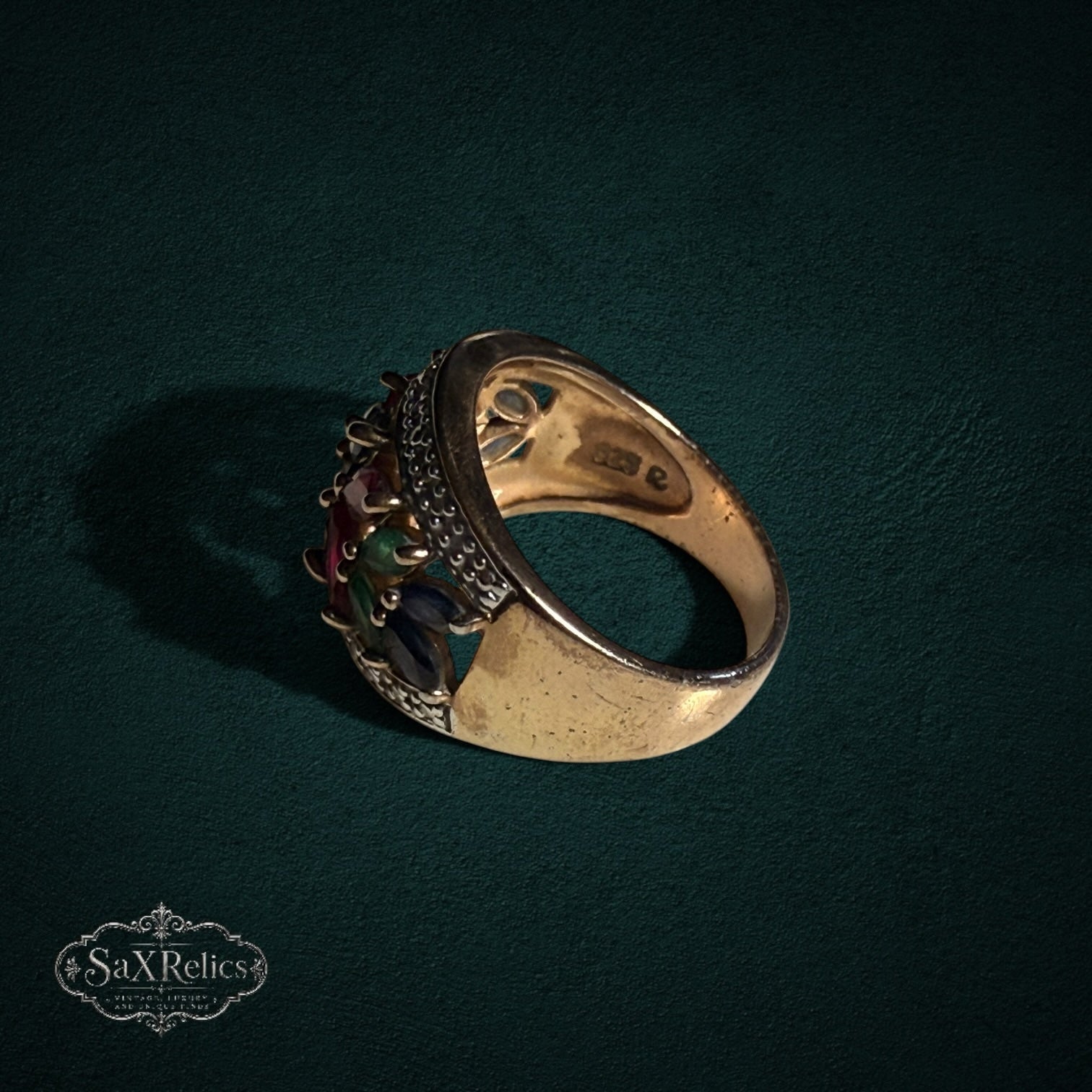 My Store statement ring featuring marquise-cut rubies, sapphires, and emeralds in a gold-tone leaf-inspired setting.