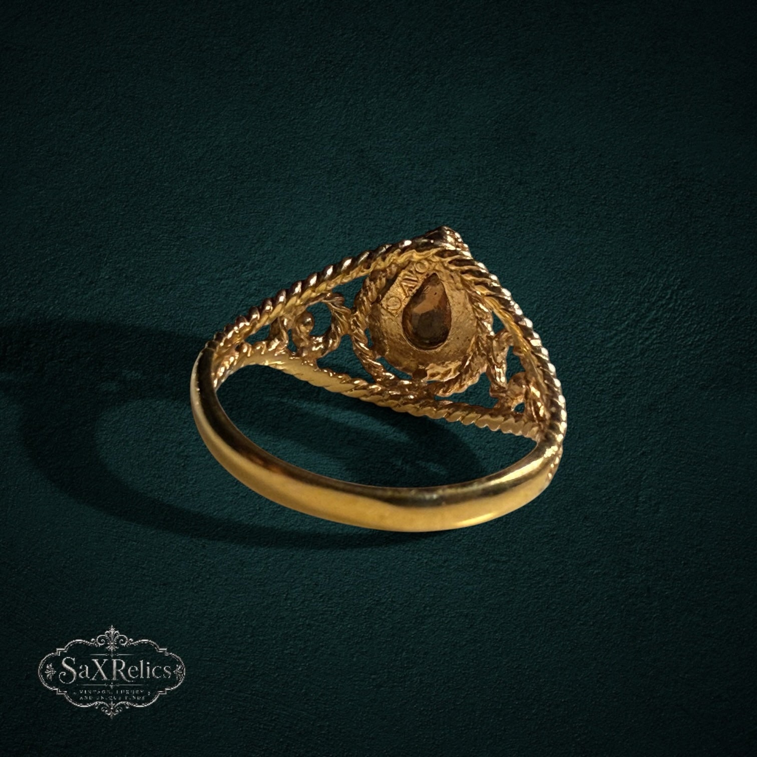 My Store SAXRelics gold ring featuring a pear-cut gemstone with an ornate twisted rope band and filigree details.