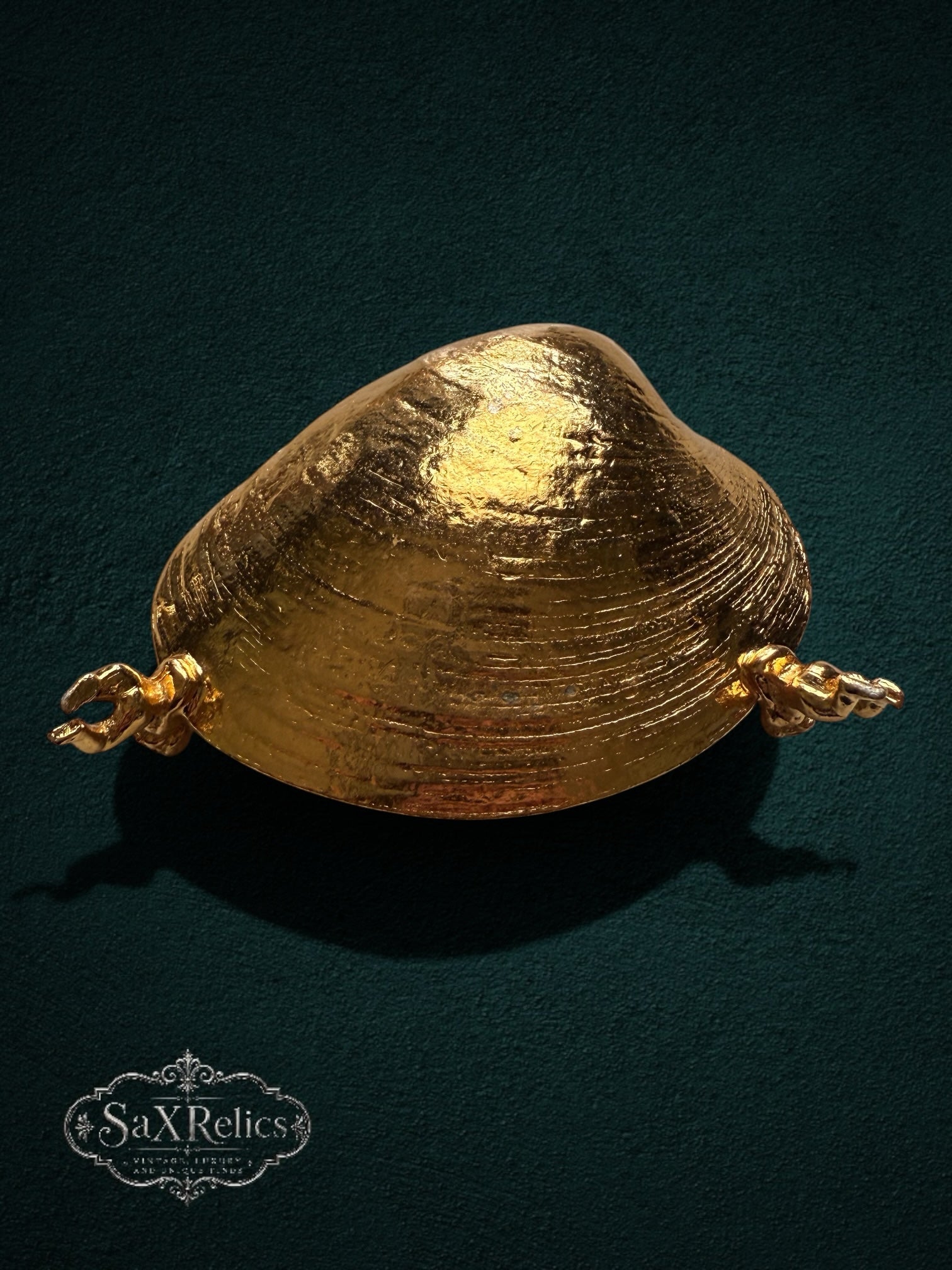 My Store gold-tone shell trinket dish featuring detailed cherub accents and a textured finish on a dark background
