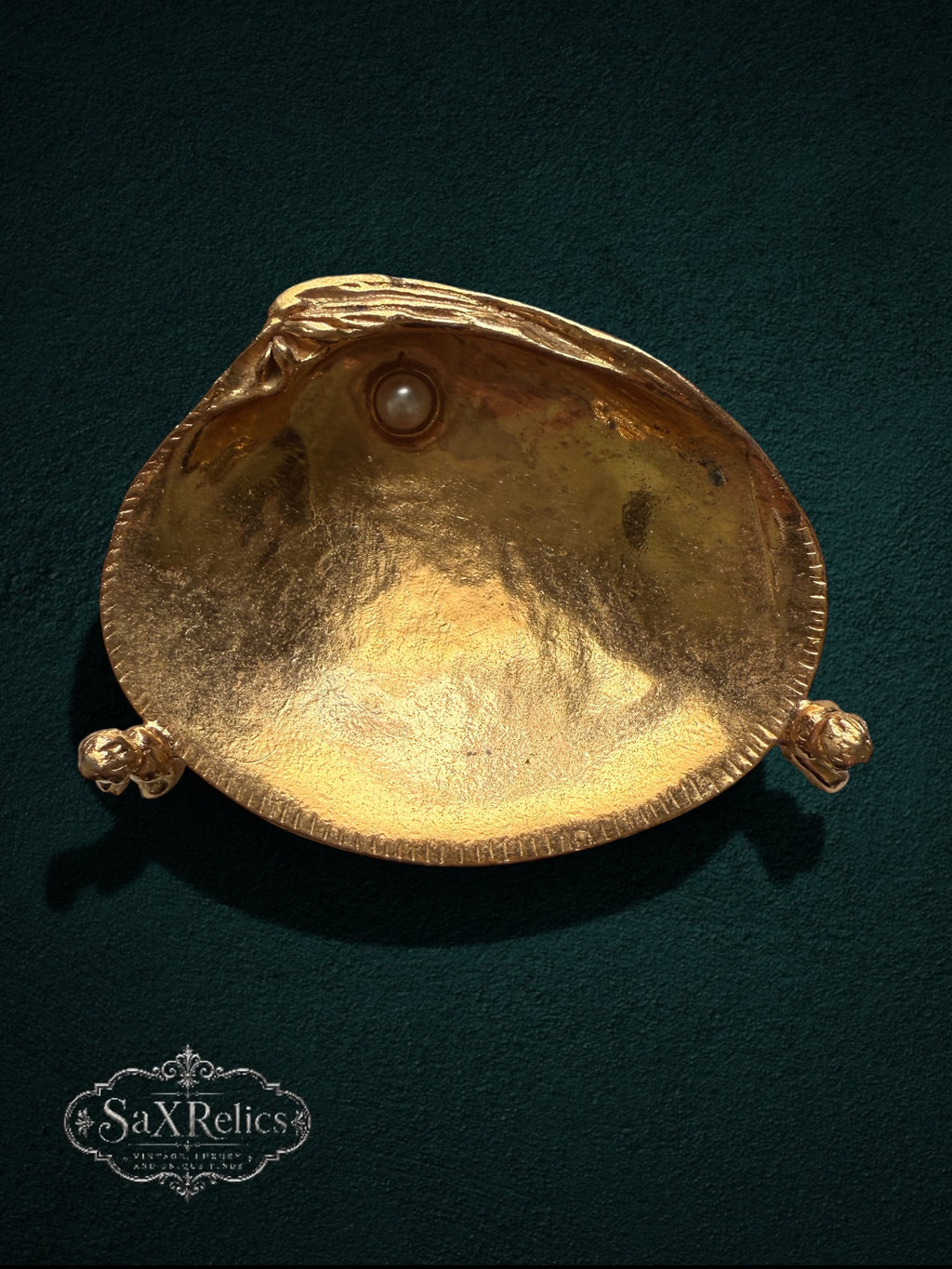 My Store gold-tone shell trinket dish with cherub accents and a faux pearl on a dark green background