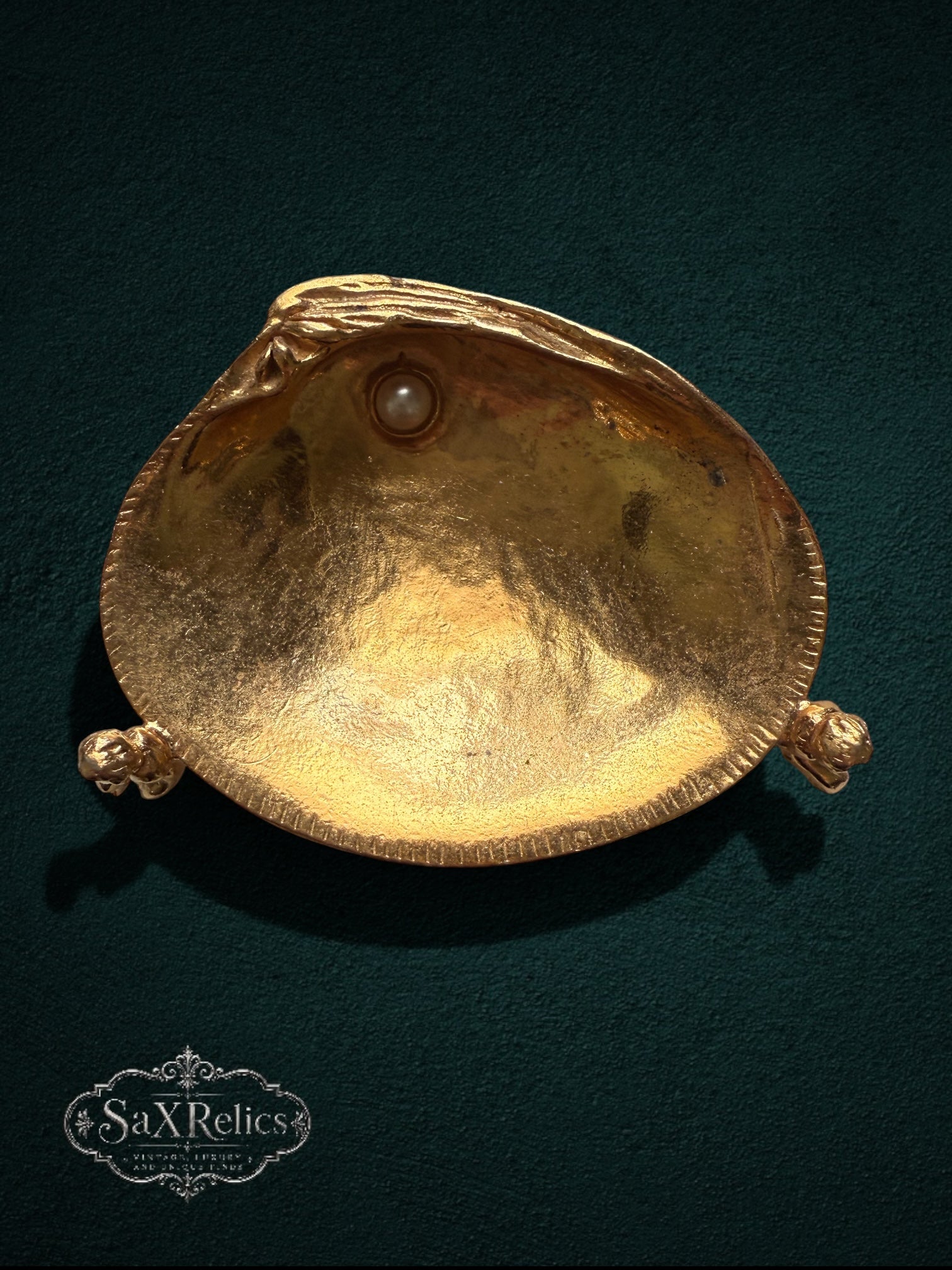 My Store gold-tone shell trinket dish with cherub accents and a faux pearl on a dark green background
