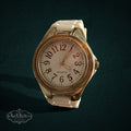 SaX Relics gold-tone bezel quartz watch with a white dial and white silicone band