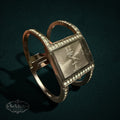 My Store golden classic quartz cuff watch with a rectangular face and crystal-accented open band design.