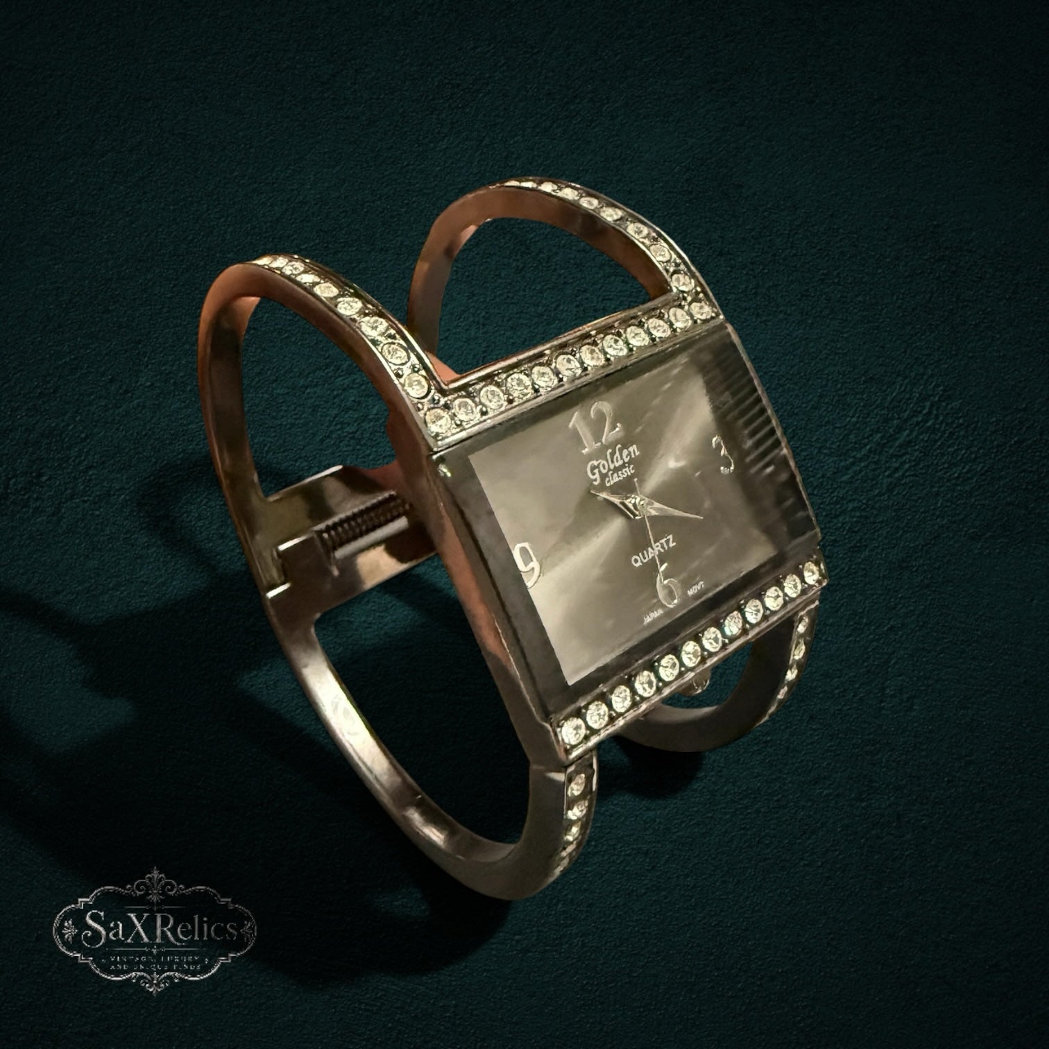 My Store golden classic quartz cuff watch with a rectangular face and crystal-accented open band design.
