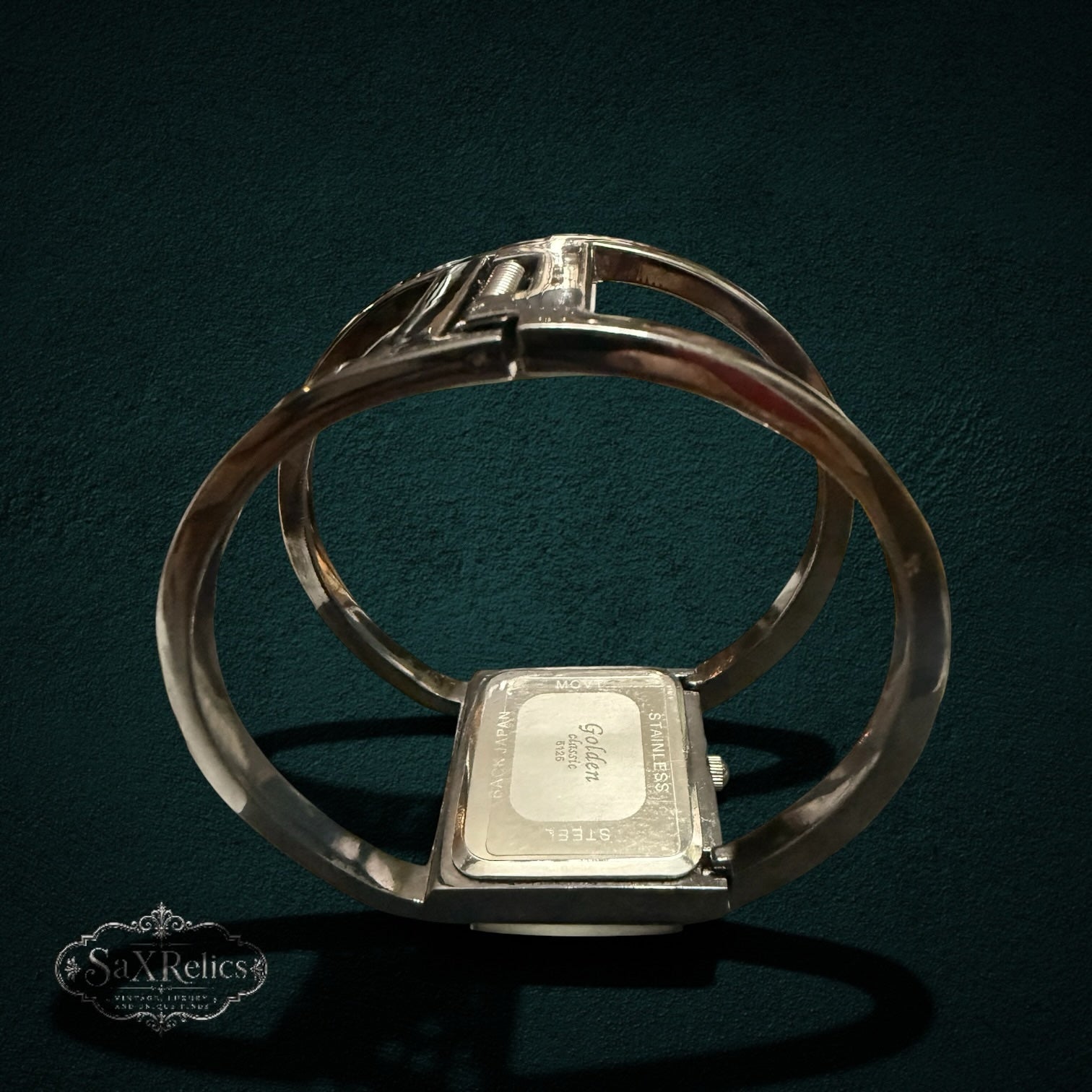 My Store Golden classic quartz cuff bracelet watch with a stainless steel back and open-cuff design on a dark background.
