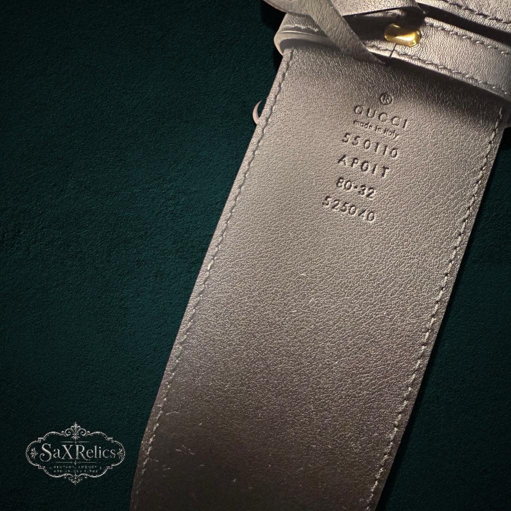 My Store Gucci belt interior showing embossed brand logo, serial number, and size details on black leather