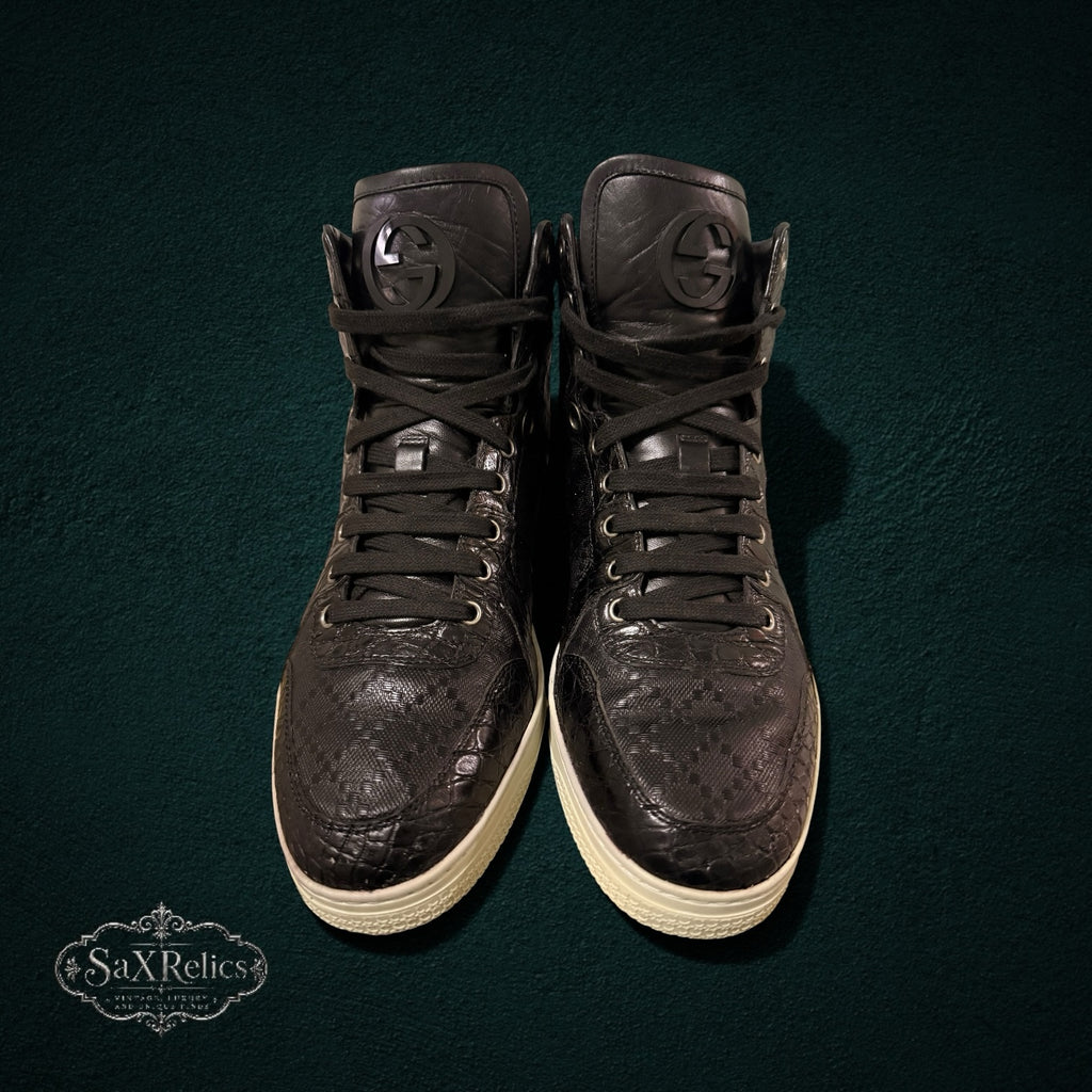 My Store Gucci black leather high-top sneakers with GG monogram pattern, textured overlays, and logo tongue emblem.
