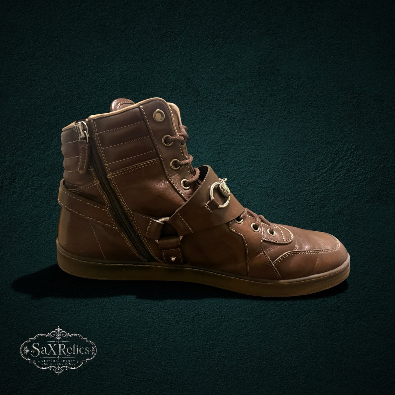 My Store Gucci brown leather high-top sneakers featuring signature horsebit hardware, side-zip closure, and rubber sole.