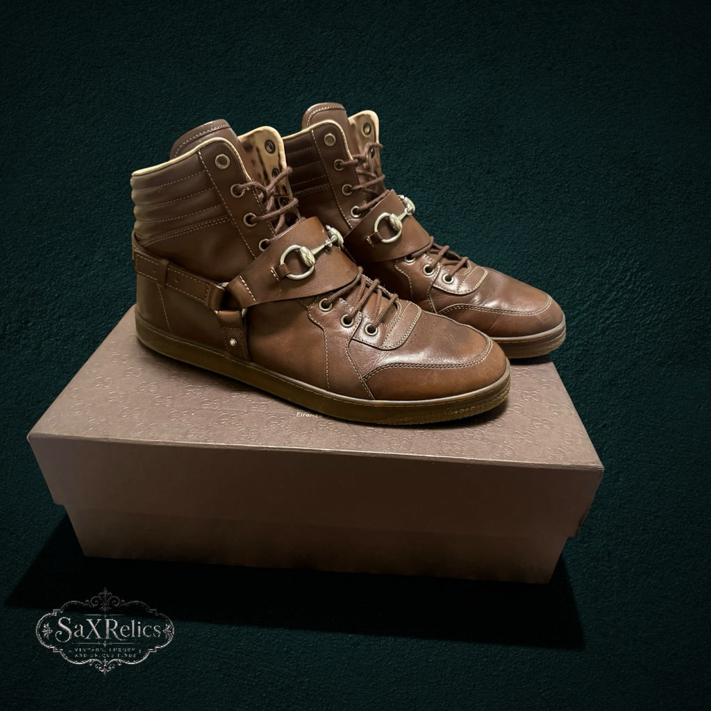 My Store brown leather Gucci high-top sneakers featuring signature horsebit hardware and a padded ankle collar.