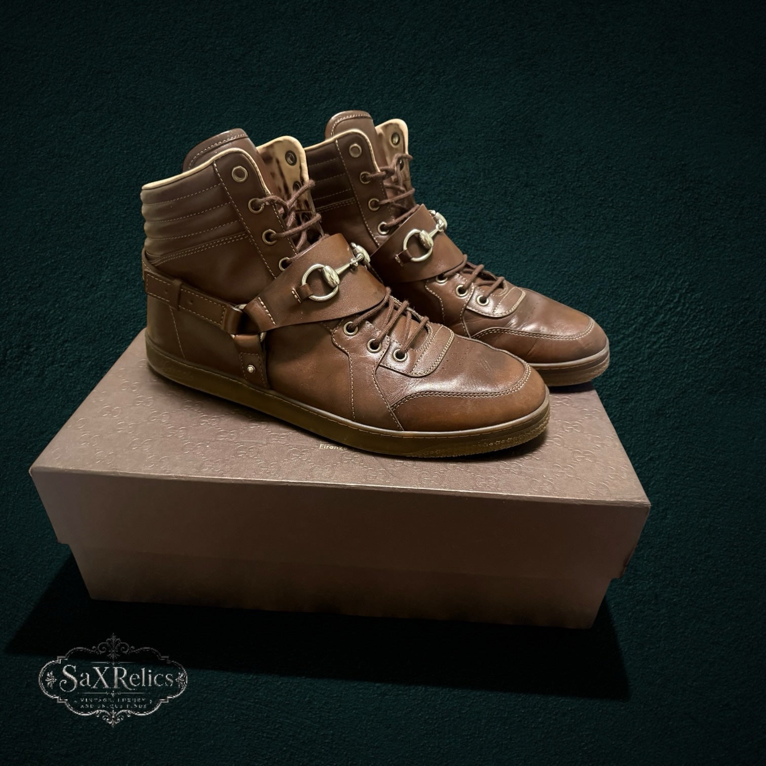 My Store brown leather Gucci high-top sneakers featuring signature horsebit hardware and a padded ankle collar.