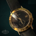My Store vintage Gucci analog wristwatch with a gold-tone Roman numeral bezel, black dial, and black leather strap.
