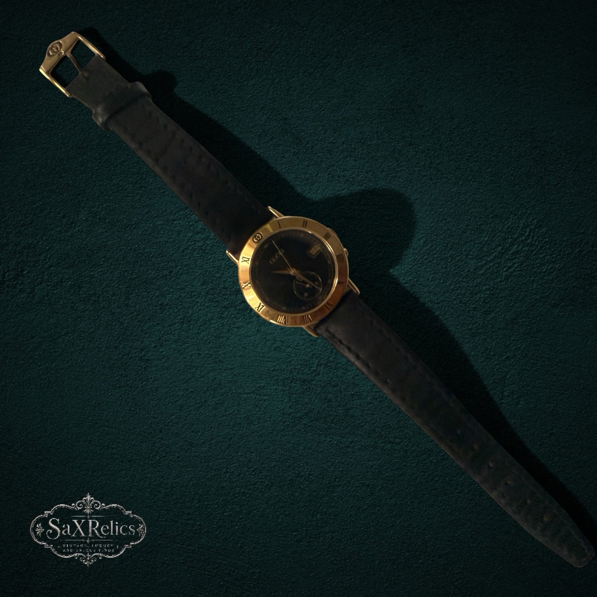 My Store vintage Gucci analog wristwatch with a gold-tone bezel, Roman numerals, and a black leather strap.
