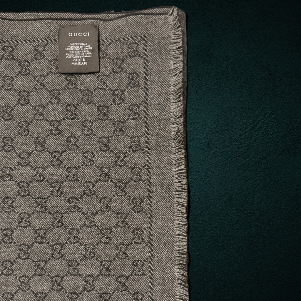 My Store Gucci grey and charcoal wool scarf featuring the iconic GG monogram pattern and delicate fringe edge detail.