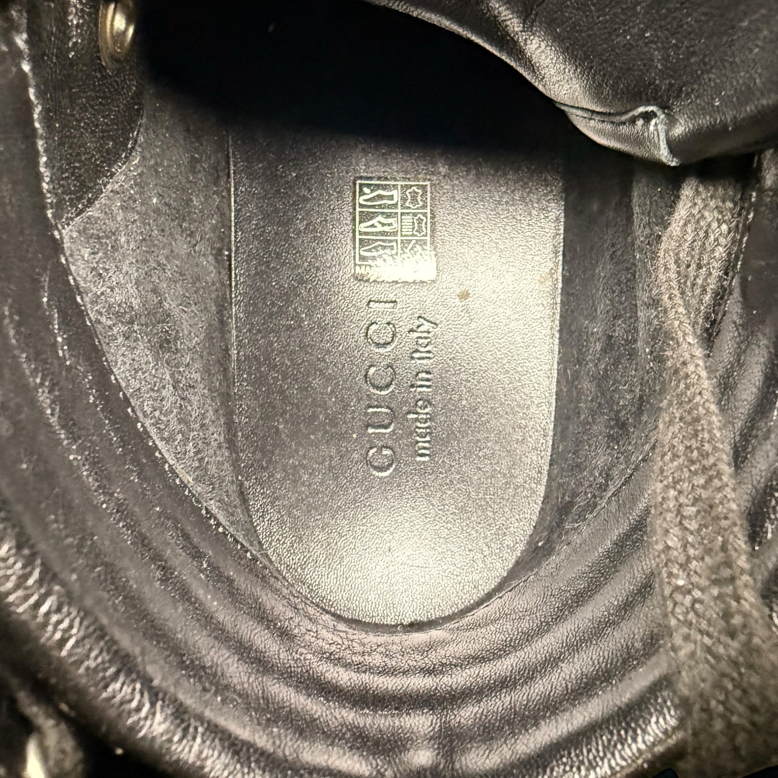 My Store Gucci black leather high-top sneaker interior showing the embossed logo and made in Italy stamp