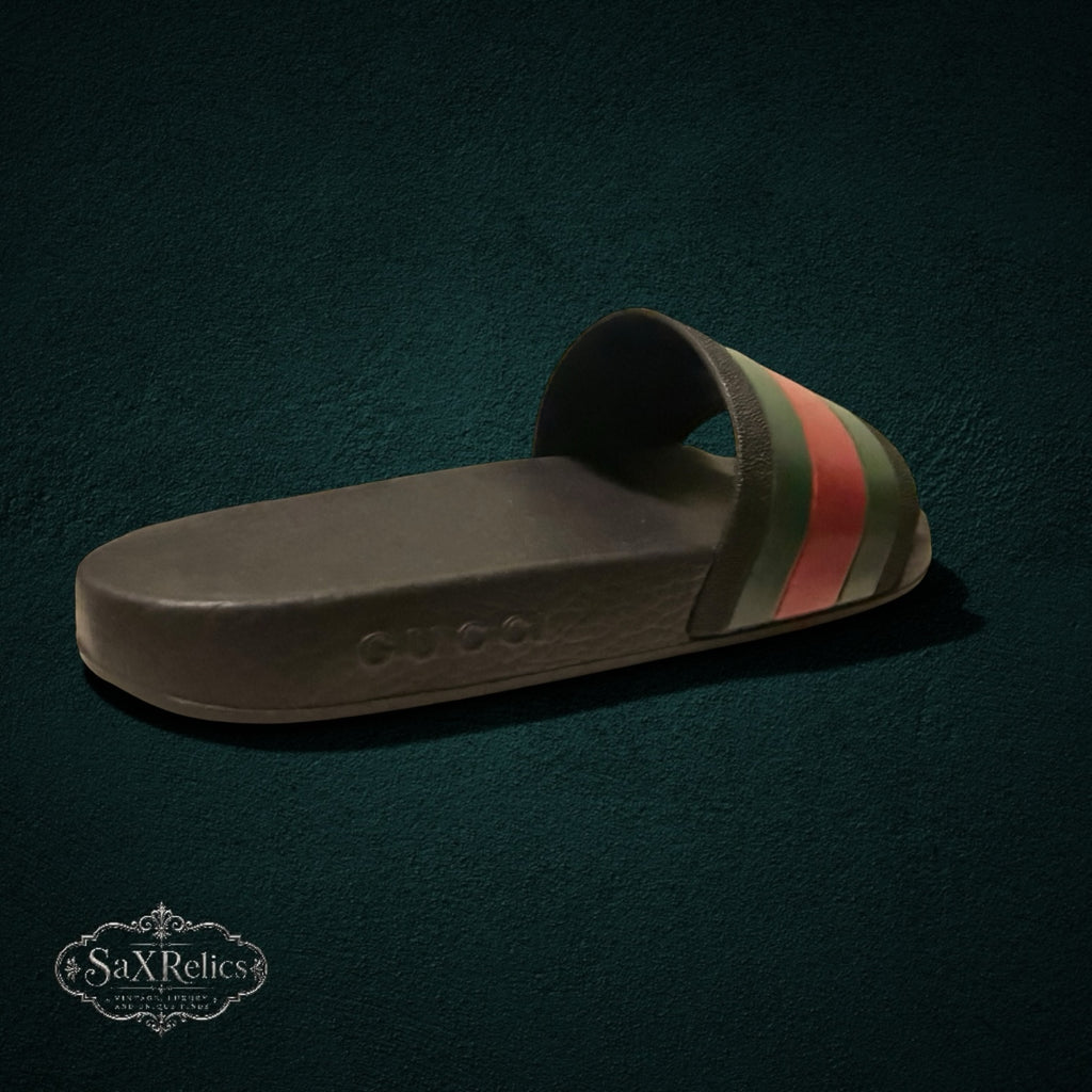 My Store GUCCI rubber slide sandals in black with signature green and red web stripe and embossed logo detail