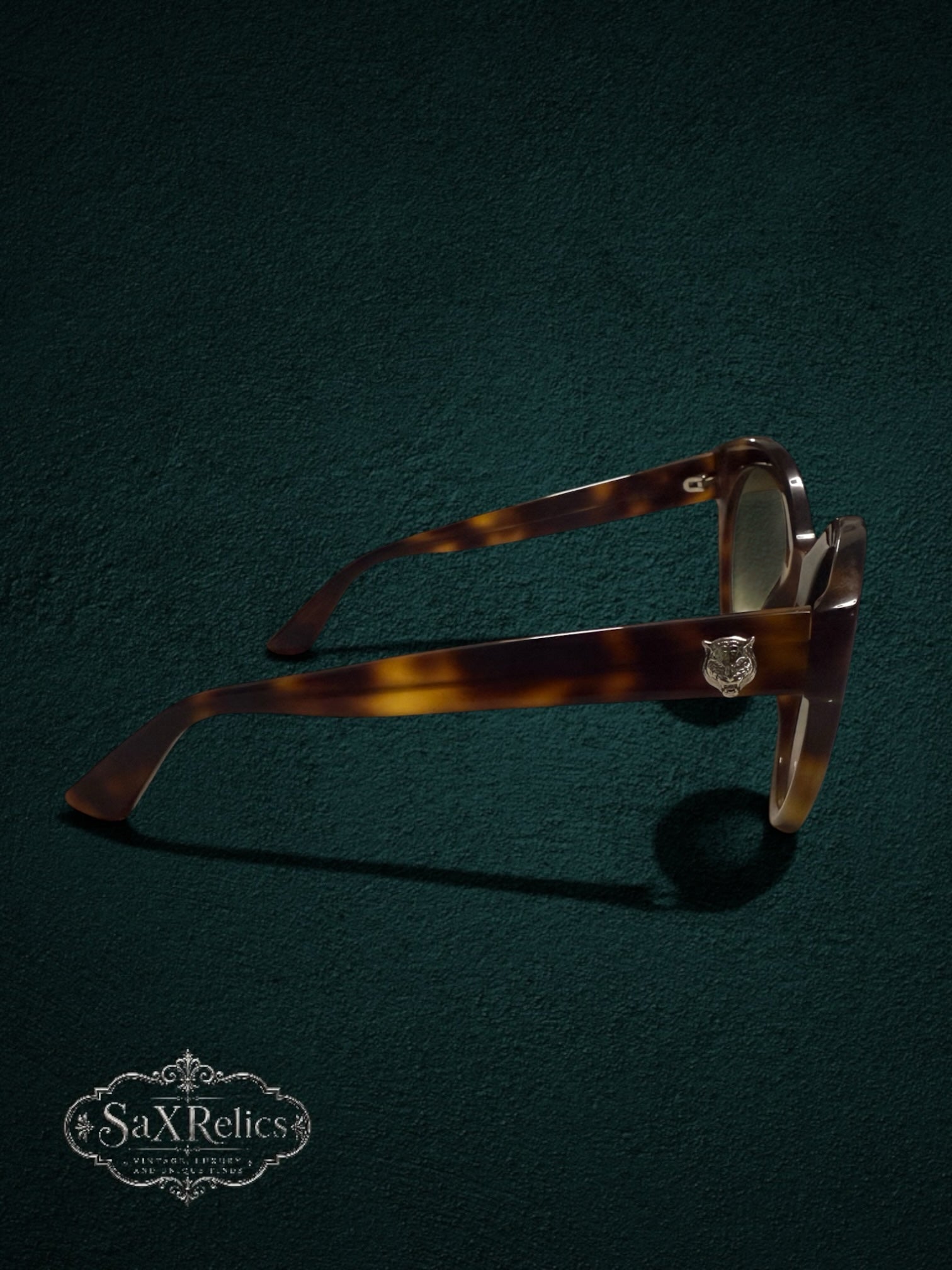 My Store Gucci cat eye sunglasses in tortoiseshell acetate with a metallic feline head emblem on the temple