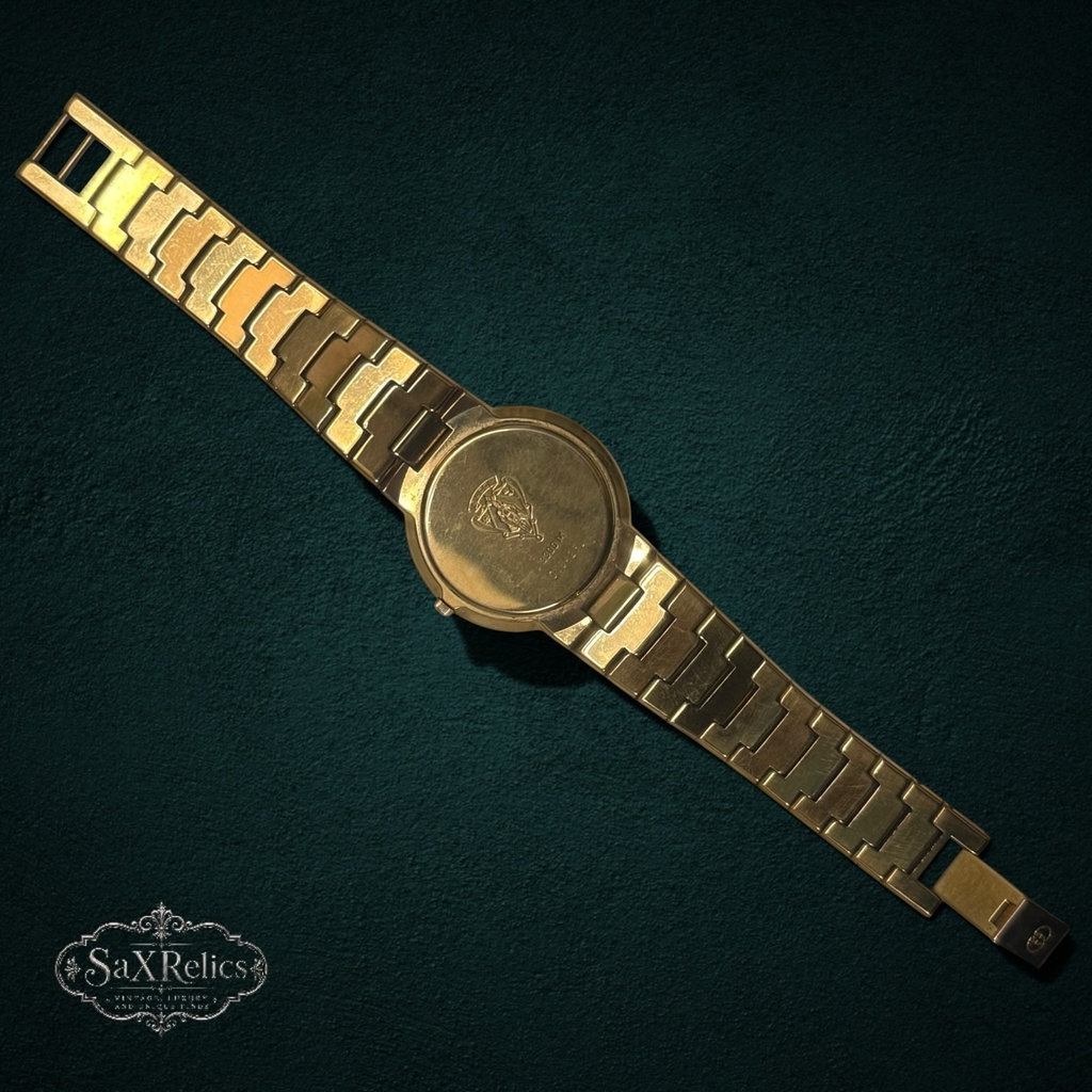 My Store vintage Gucci 3300M gold-tone wristwatch showing the engraved case back and link bracelet.