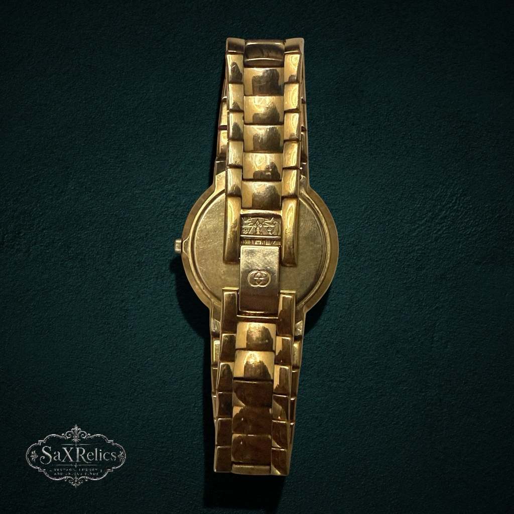 My Store vintage Gucci 3300M gold-tone link bracelet watch showing the back case with iconic logo engraving