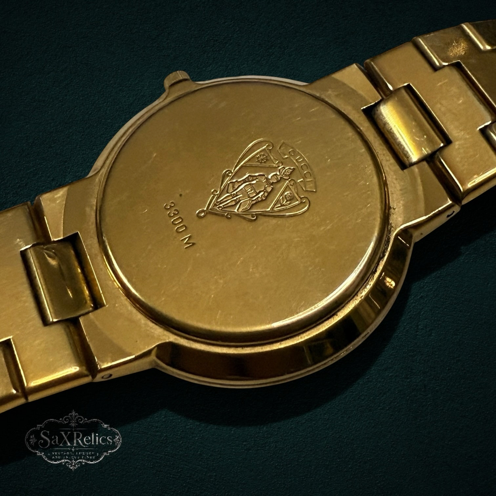 My Store vintage Gucci 3300M gold-tone wristwatch case back with engraved crest and model number