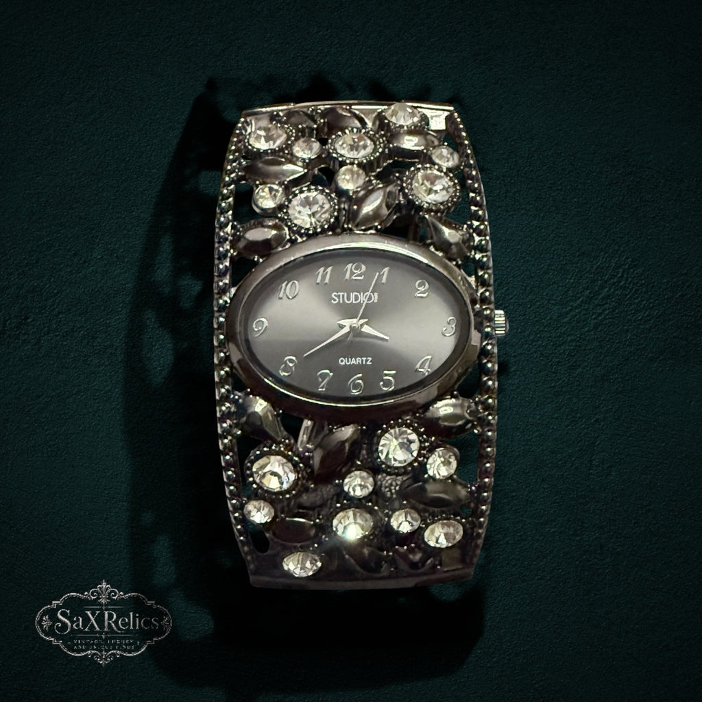 My Store STUDIO gunmetal cuff watch with an oval dial and ornate crystal-encrusted open-work band