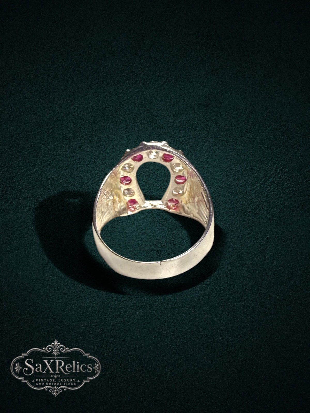 My Store sterling silver horseshoe statement ring featuring vibrant red rubies and clear stones with textured sides.