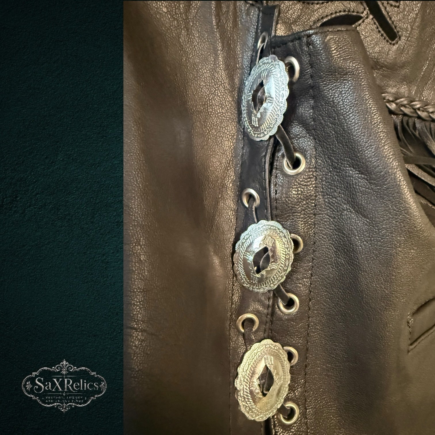 My Store black leather motorcycle vest side detail with silver conchos and adjustable lace-up closure