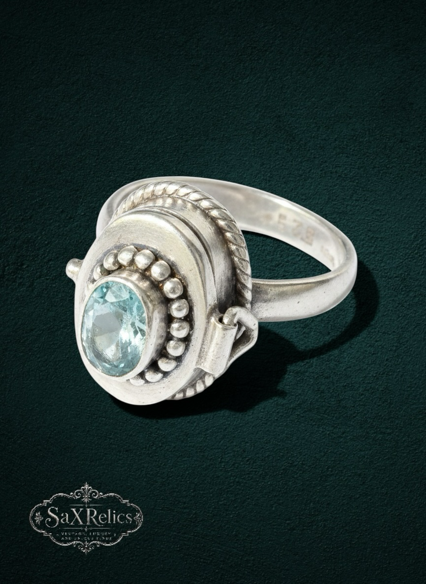 My Store sterling silver locket ring with an oval light blue gemstone, bead detailing, and twisted rope border.