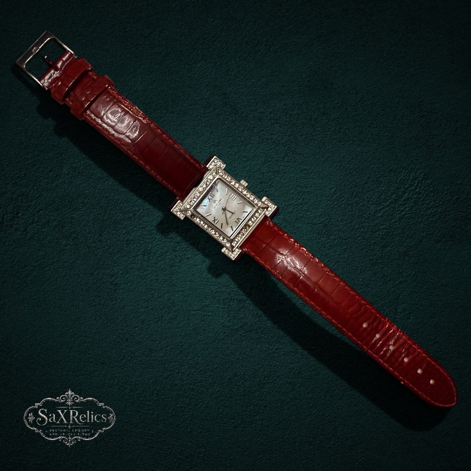 SaX Relics Louis Arden Paris rectangular watch with a mother-of-pearl dial, crystal-set bezel, and red leather strap