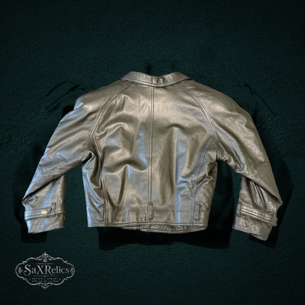 Metallic silver-grey leather jacket, back view showing cropped fit and star-embossed cuff buttons.