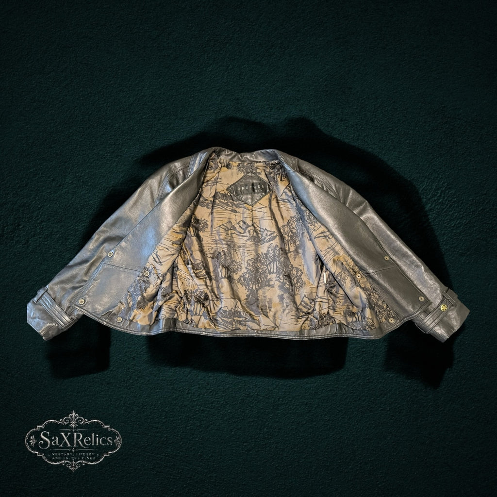 BROTHERS metallic silver leather jacket with double-breasted design and artistic landscape print lining.