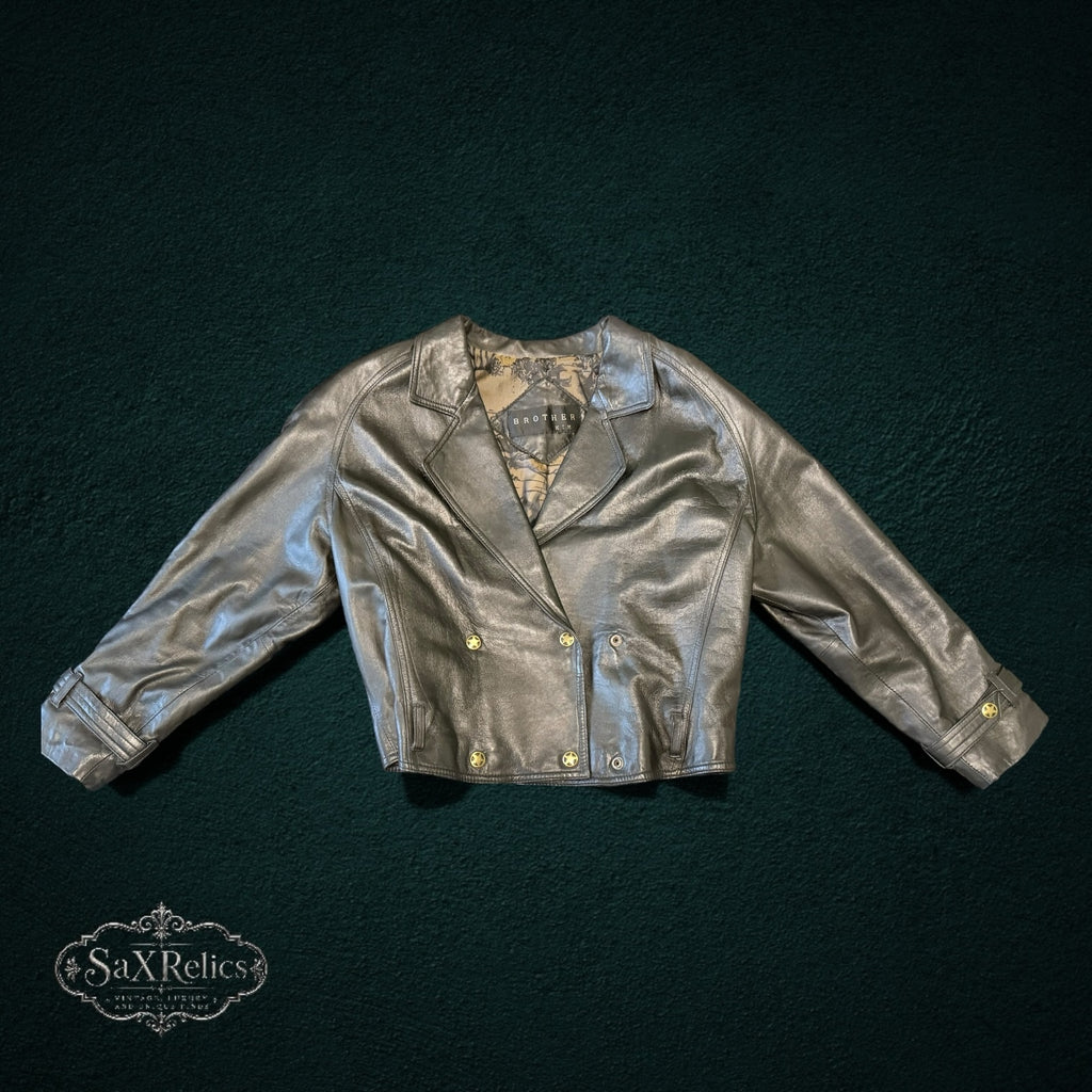 BROTHERS metallic silver-grey leather double-breasted cropped jacket with gold star-embossed buttons.