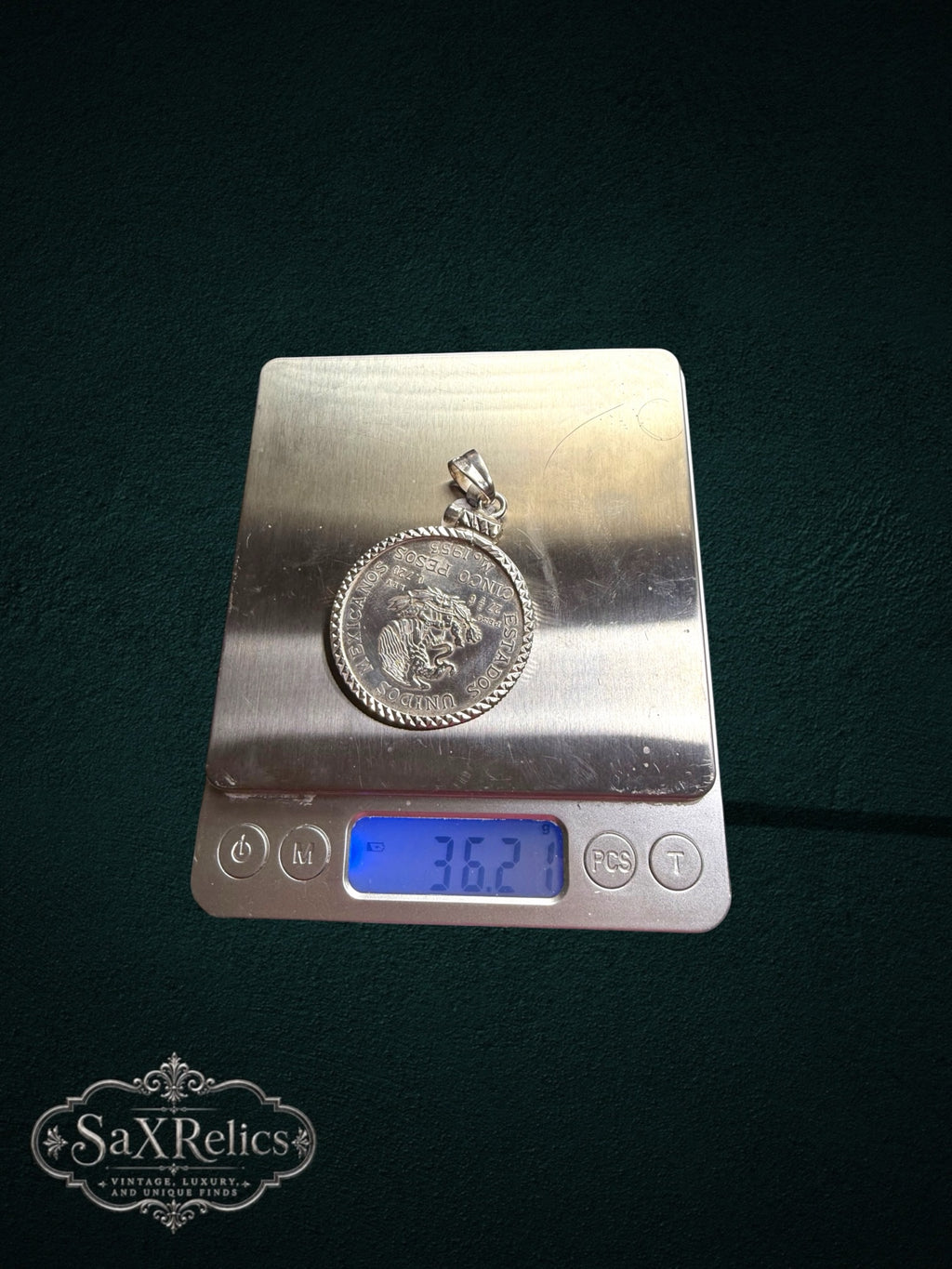 My Store vintage 1953 Mexican Cinco Pesos silver coin pendant with a textured bezel weighing 36.2 grams on a scale.