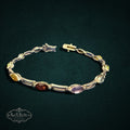 My Store multi-gemstone link bracelet featuring marquise-cut colorful stones set in a polished metal frame.