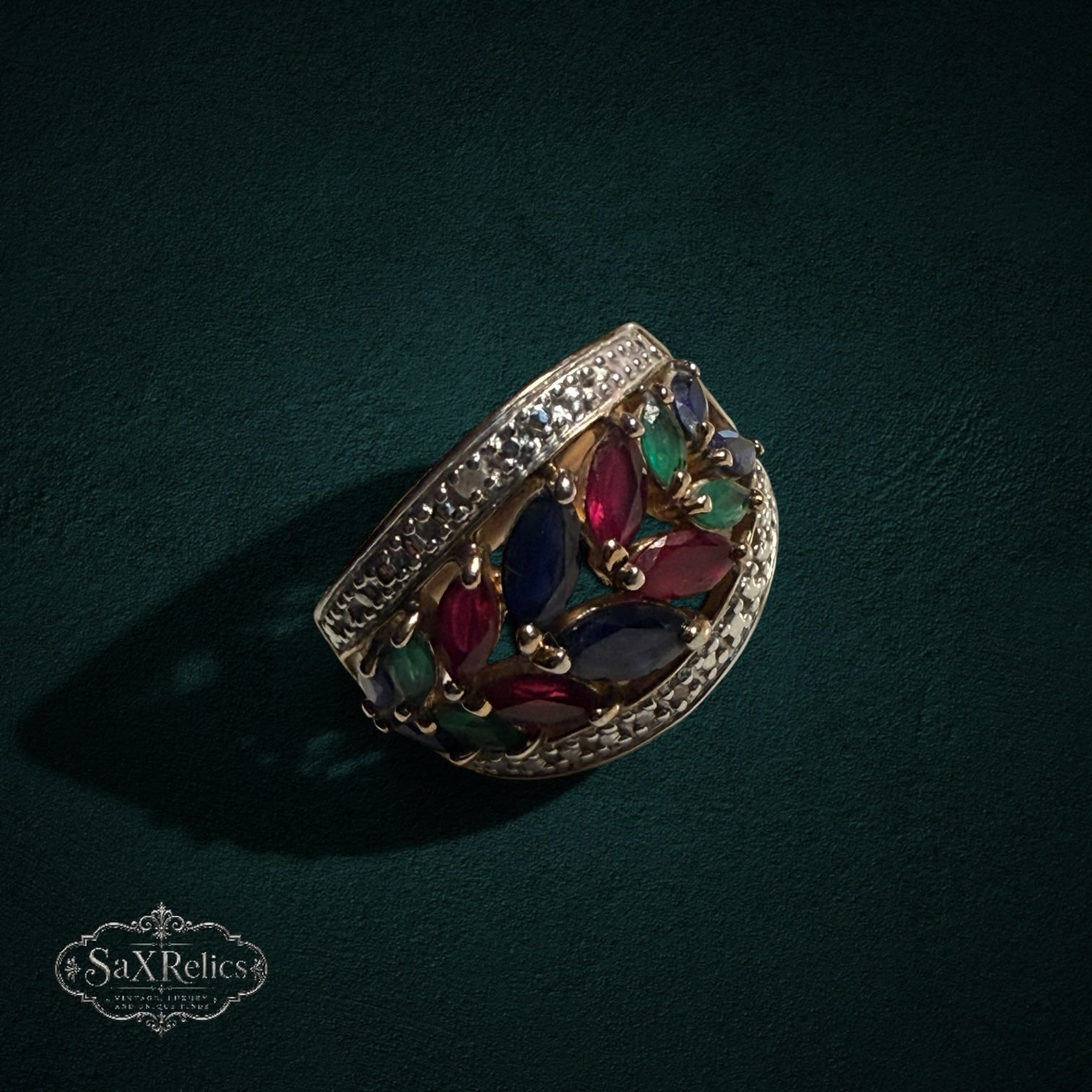 My Store statement ring featuring marquise-cut rubies, sapphires, and emeralds in a gold-tone leaf-inspired setting.