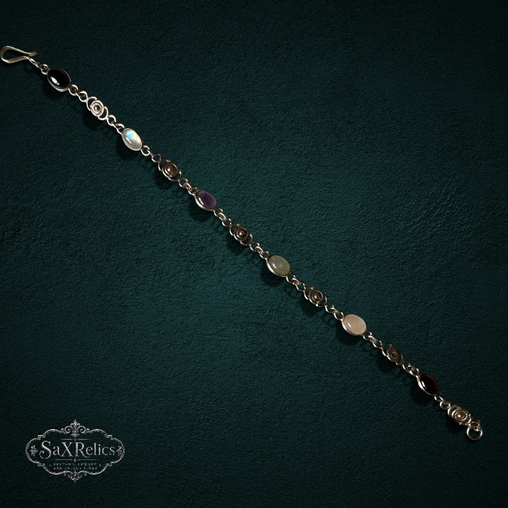 SaX Relics — Espiral sterling silver multi-stone bracelet showing carnelian, quartz, aventurine, amethyst and onyx.