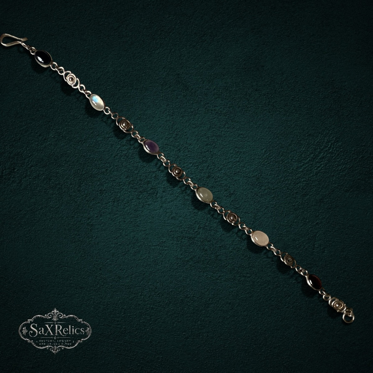 SaX Relics — Espiral sterling silver multi-stone bracelet showing carnelian, quartz, aventurine, amethyst and onyx.