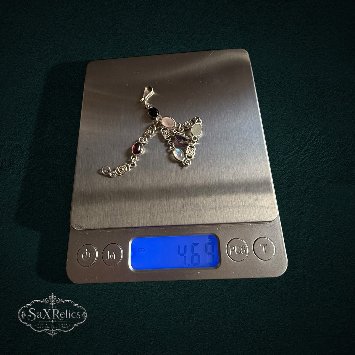SaX Relics — Espiral sterling silver multi-stone bracelet on a digital scale at 4.69 grams.