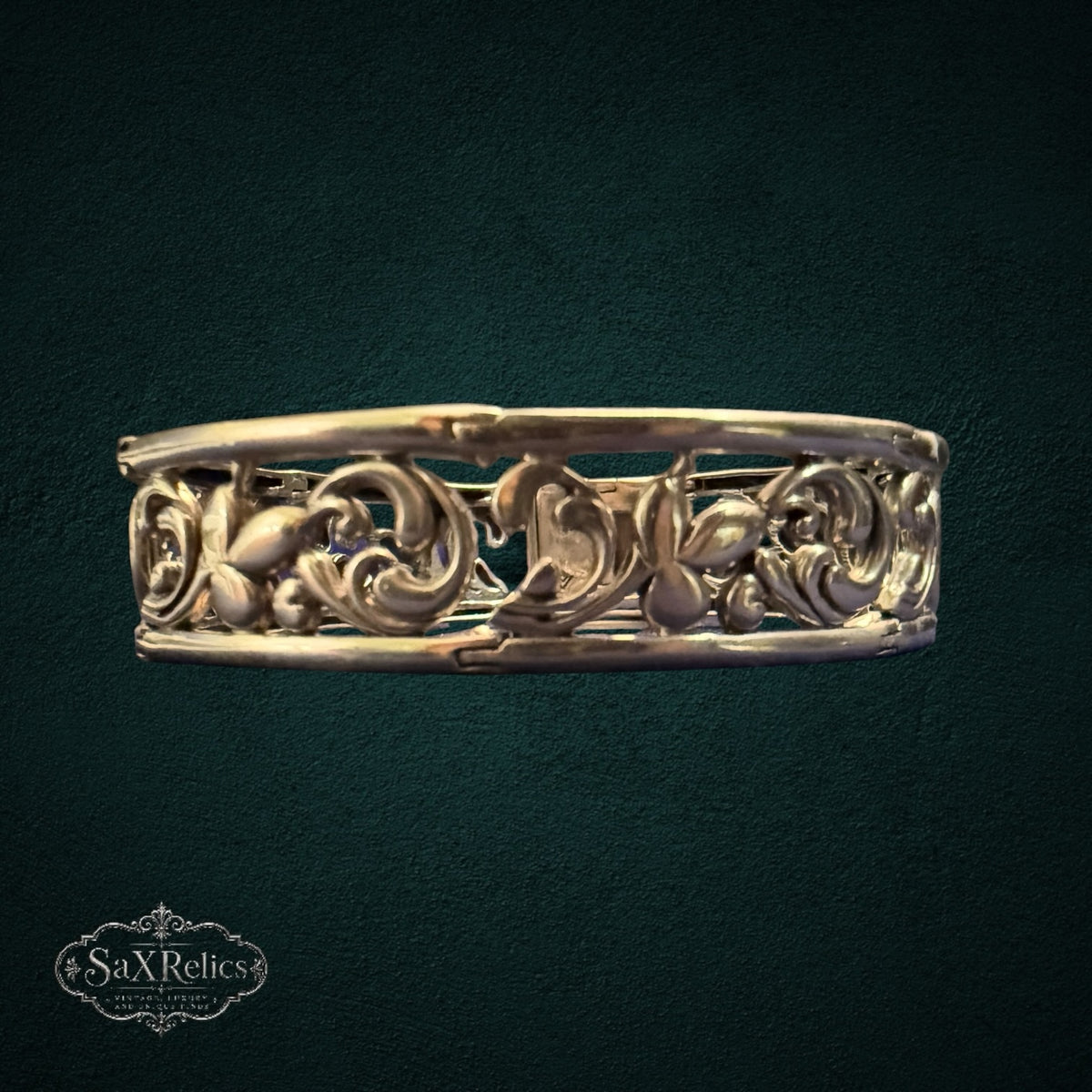 SaX Relics vintage sterling silver filigree hinged bangle showing floral and scroll motifs