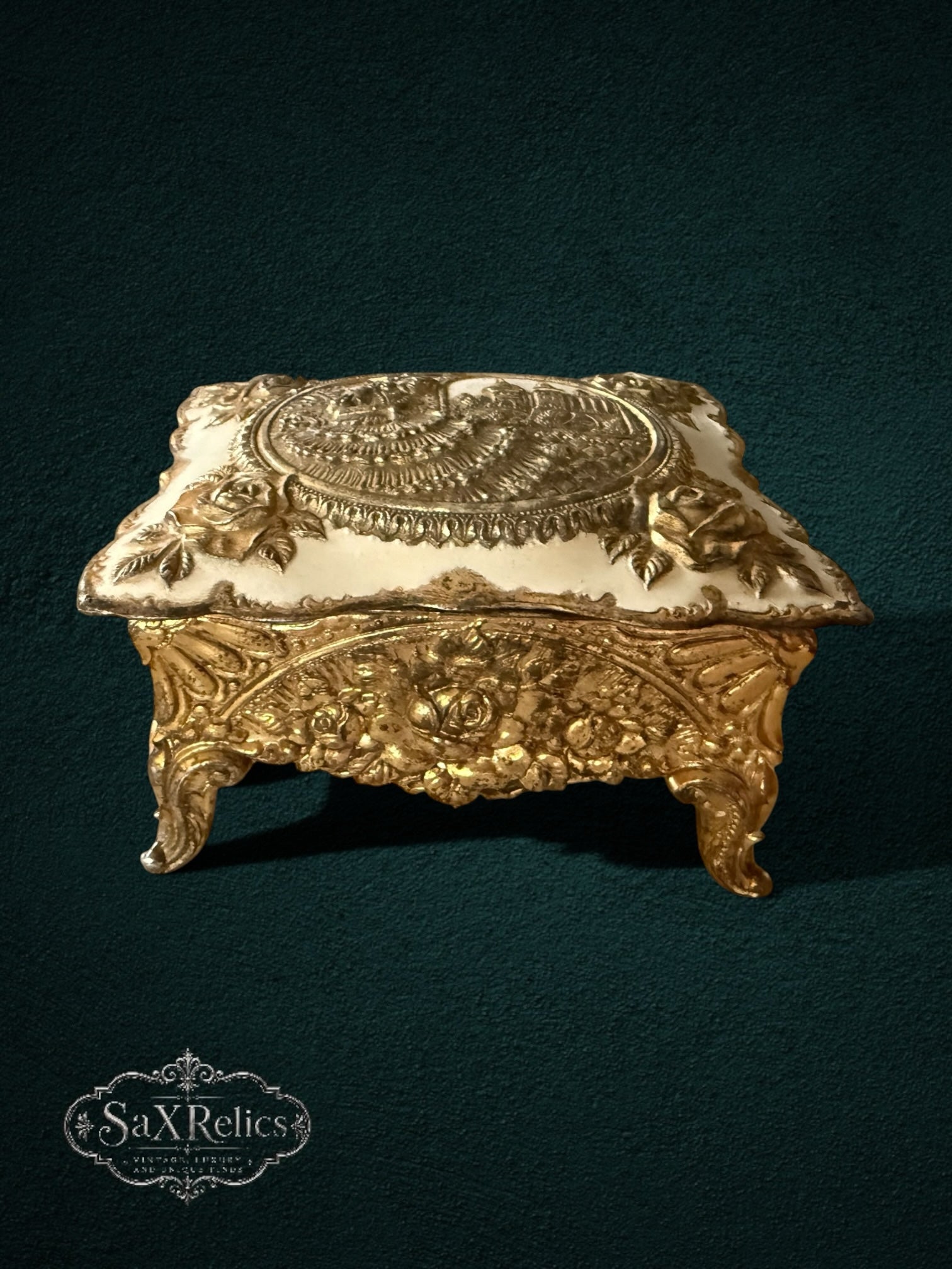 My Store ornate gold-tone metal keepsake box with floral relief, off-white lid, and architectural medallion detail.