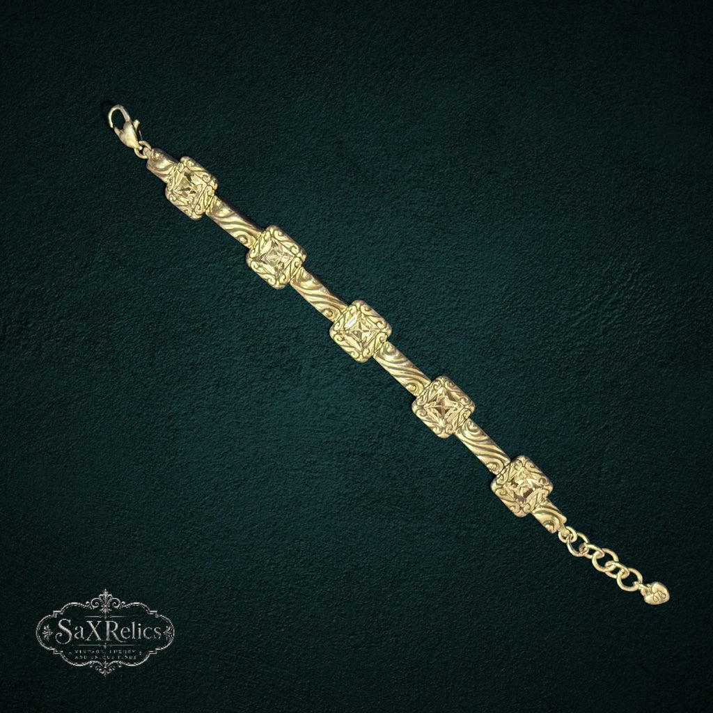 SaX Relics Brighton silver-plated Swarovski crystal scrollwork bracelet on a dark textured background