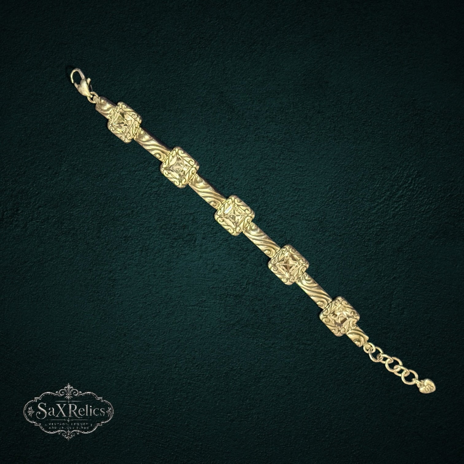 SaX Relics Brighton silver-plated Swarovski crystal scrollwork bracelet on a dark textured background