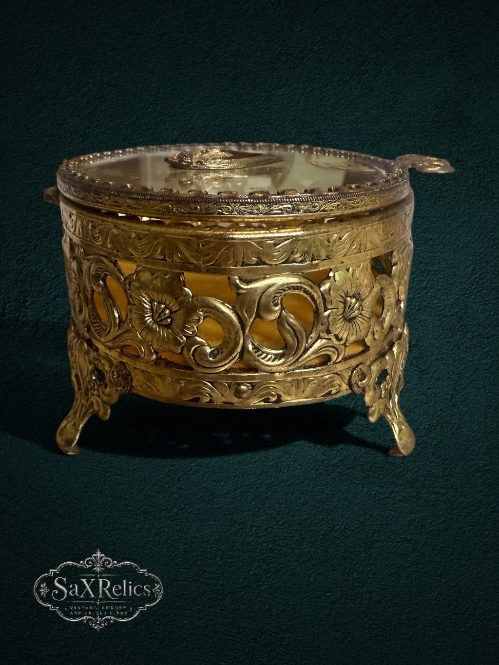 My Store ornate gold-tone metal trinket box with floral filigree, glass lid, and velvet lining on decorative feet.